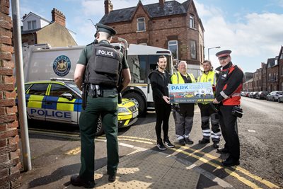 Councillor Micky Murray, Chair of the council’s People and Communities Committee with officers from the Waste Collections team, PSNI and DfI.