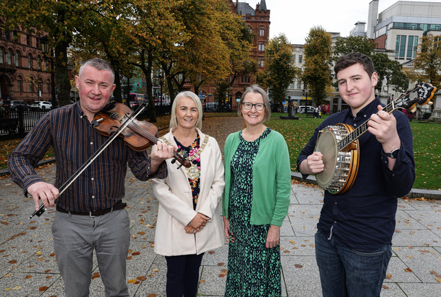 Niall McClean (with fiddle) and Ciaran McCusker (holding banjo) of Ards CCE  pictured with Lord Mayor of Belfast, Councillor Tracy Kelly and Denise Hayward of Volunteer Now