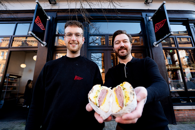 Steven Orr, owner of Bodega Bagels with Cllr Sam Nelson, Chair of Belfast City Council City Growth and Regeneration Committee outside the shop on Royal Avenue