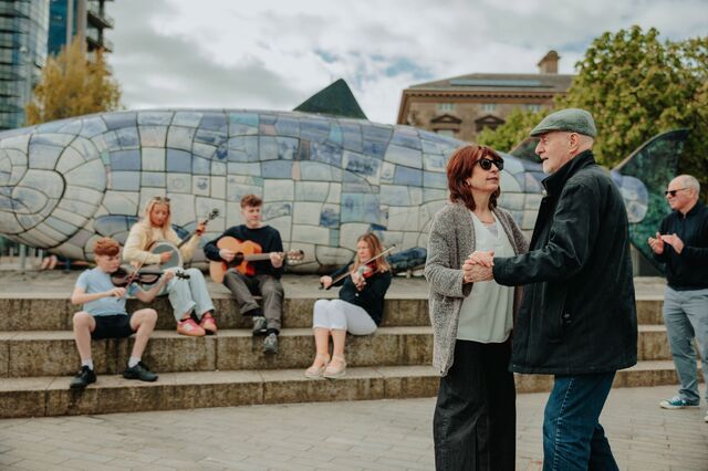 Musicians and people dancing at the Big Fish