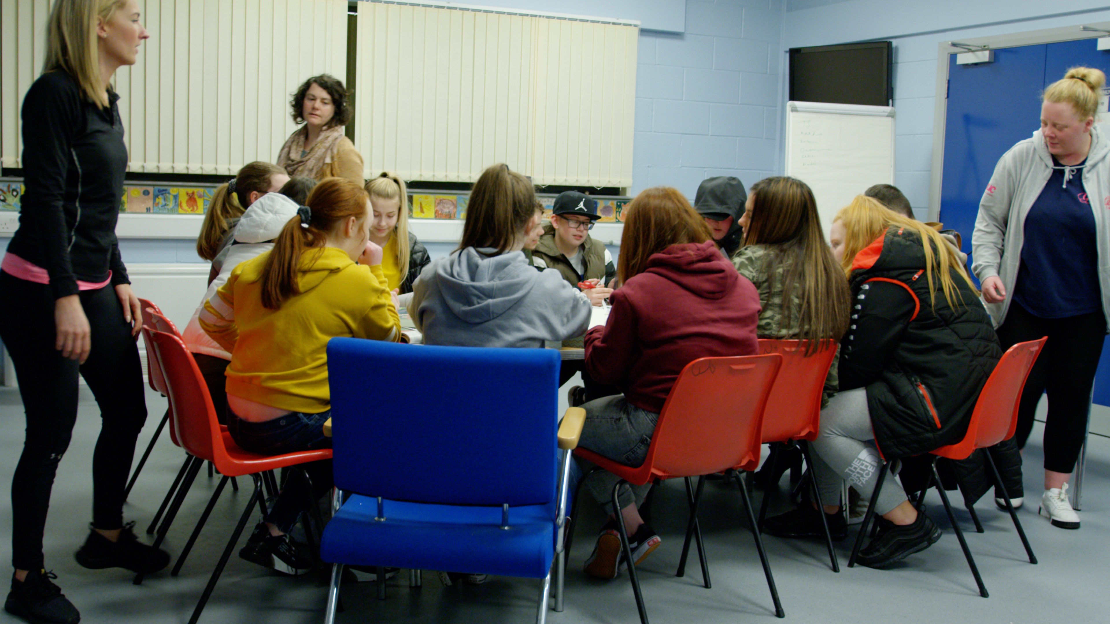 A group of children in a classroom taking part in