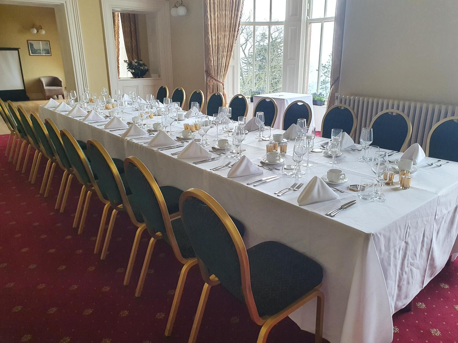 Ben Madigan Room set up with 10 chairs on either side of a long table for a wedding.