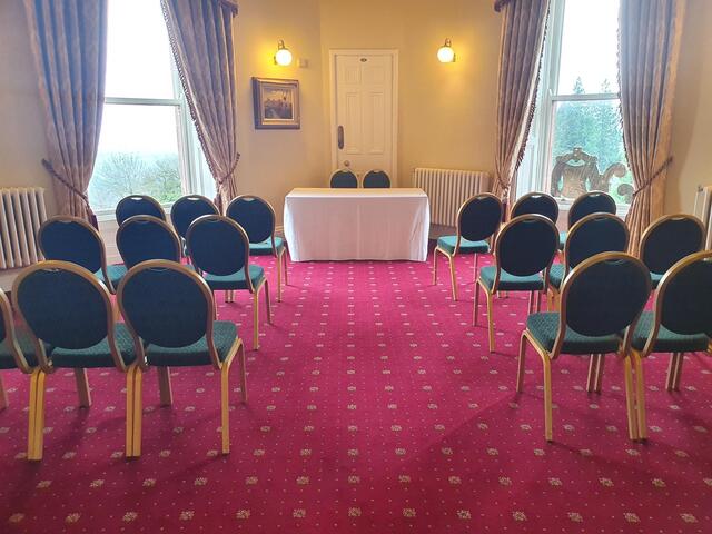 Fisherwick Room set up for an intimate wedding ceremony with chairs on either side of an aisle and a table for the couple.