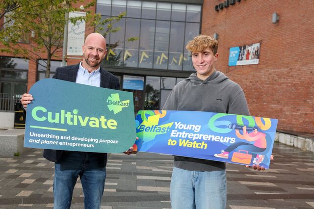 Councillor Joe Duffy holds a sign advertising the Cultivate business programme, with young business owner Max Loebnau who holds a sign advertising the Young Entrepreneurs to Watch competition. 