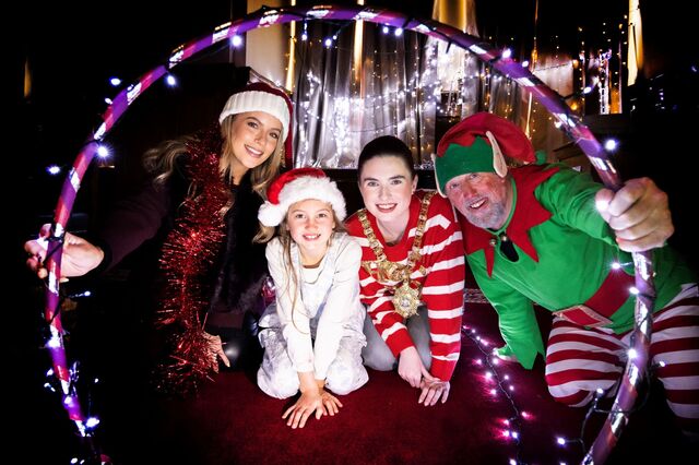 Melissa Riddell from Cool FM, young female, Lord Mayor of Belfast, Councillor Róis-Máire Donnelly, and festive elf get ready for Belfast's Christmas lights switch-on event.