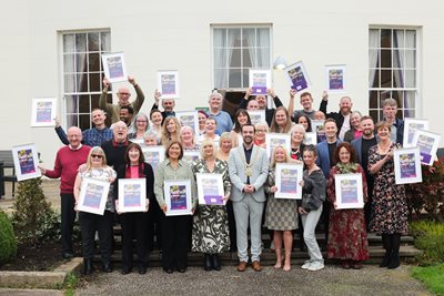 Lord Mayor Councillor Micky Murray with winners of Belfast in Bloom Awards holding their certificates in front of Malone House