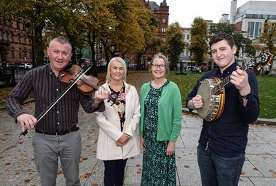 Niall McClean (with fiddle) and Ciaran McCusker (holding banjo) of Ards CCE pictured with Lord Mayor of Belfast, Councillor Tracy Kelly and Denise Hayward of Volunteer Now