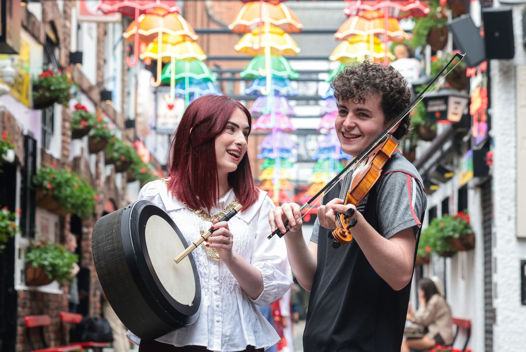 Lord Mayor of Belfast and Ards CCÉ musician play instruments in a busy Belfast street.