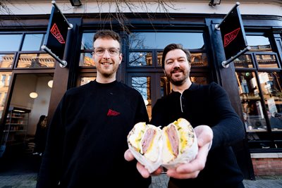 Steven Orr, owner of Bodega Bagels with Cllr Sam Nelson, Chair of Belfast City Council City Growth and Regeneration Committee outside the shop on Royal Avenue