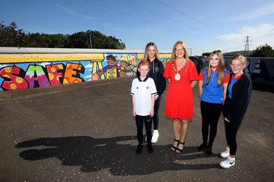 Lord Mayor pictured with local young people at new mural on The Dee Street Bridge