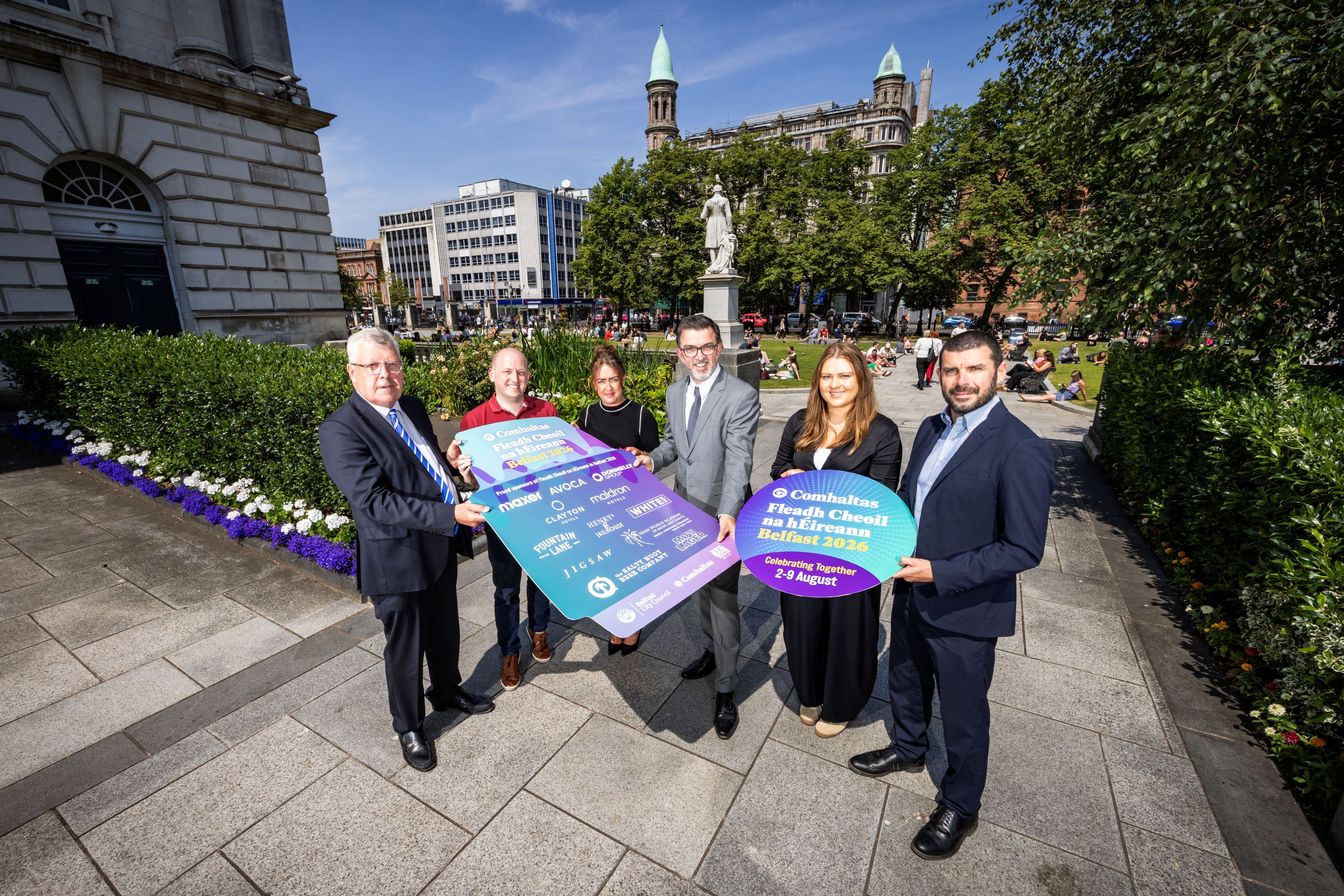 Sponsors of this year's Fleadh Cheoil na hÉireann gathered around a prop board displaying their logos outside City Hall.
