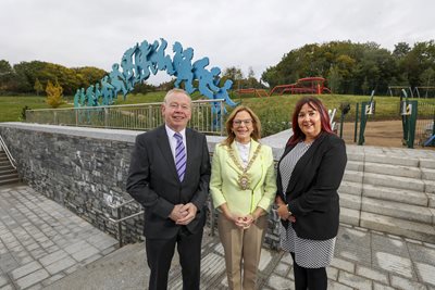 Patrick Anderson from the Department for Communities, Belfast Lord Mayor Councillor Christina Black and Joan O’Hara from Urban Villages at the entrance to Páirc Nua C