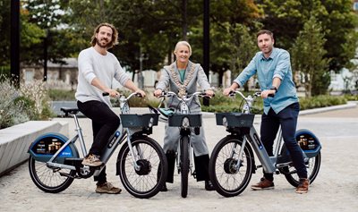 Phil Ellis, Beryl CEO, Lord Mayor of Belfast, Councillor Tracy Kelly, and Jonathan Henderson from the Department for Infrastructure’s Active Travel Unit, pictured on the upgraded Belfast Bikes.