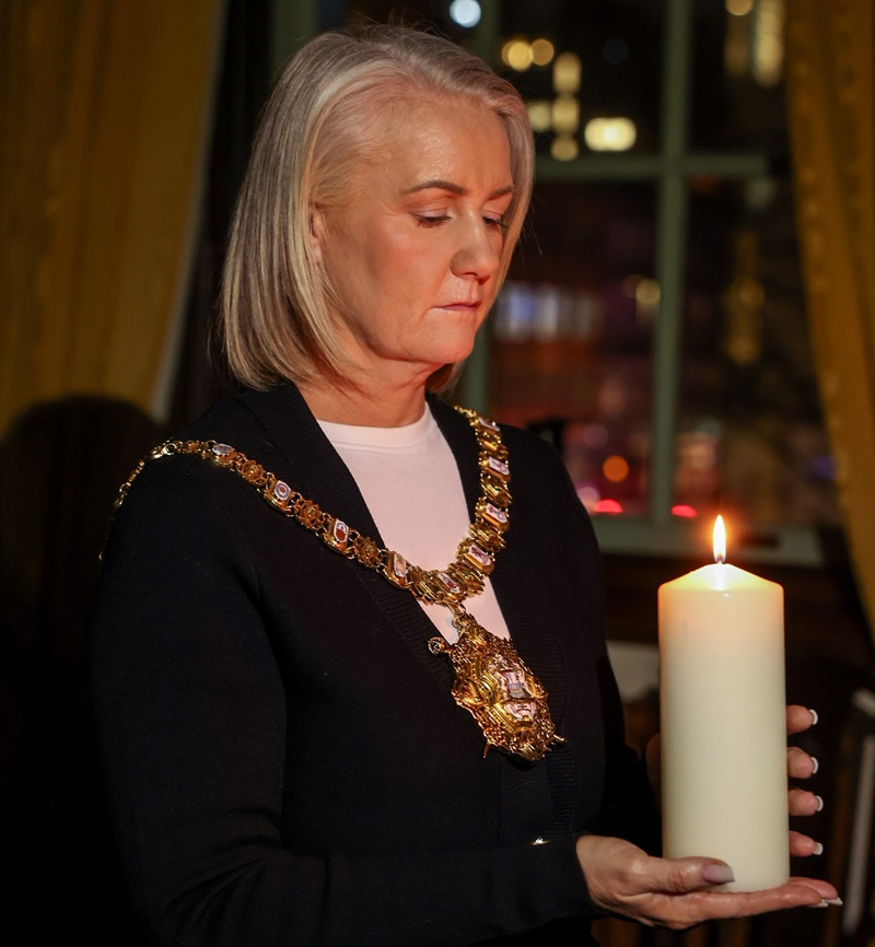 Lord Mayor of Belfast, Councillor Tracy Kelly, lights a candle to mark Holocaust Memorial Day.