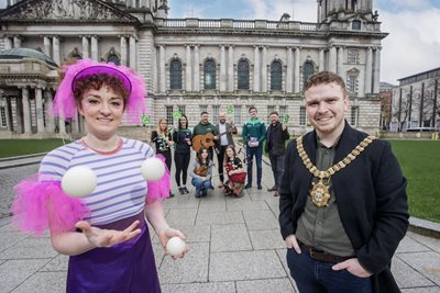 Lord Mayor of Belfast, Councillor Ryan Murphy, and circus performer Louise Glendinning join local musicians and representatives from Belfast Tradfest, Conradh na Gaeilge and Féile an Phobail.
