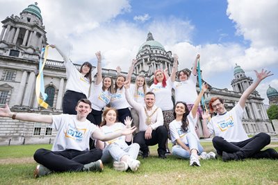 Lord Mayor and volunteers in One Young World t-shirts outside City Hall