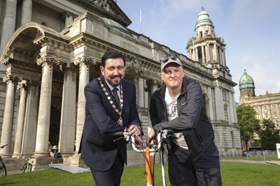 Deputy Lord Mayor of Belfast, Councillor Paul Doherty and Stephen McNally from Cycul on lawns of City Hall with a brompton bike