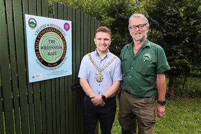 Lord Mayor of Belfast Councillor Ryan Murphy pictured alongside Chair of the Cave Hill Conservation Cormac Hamill beside visitor sign in the recently refurbished Millennium Maze at Belfast Castle.