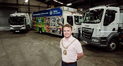 Councillor Ryan Murphy pictured with HGV vehicles at Duncrue complex