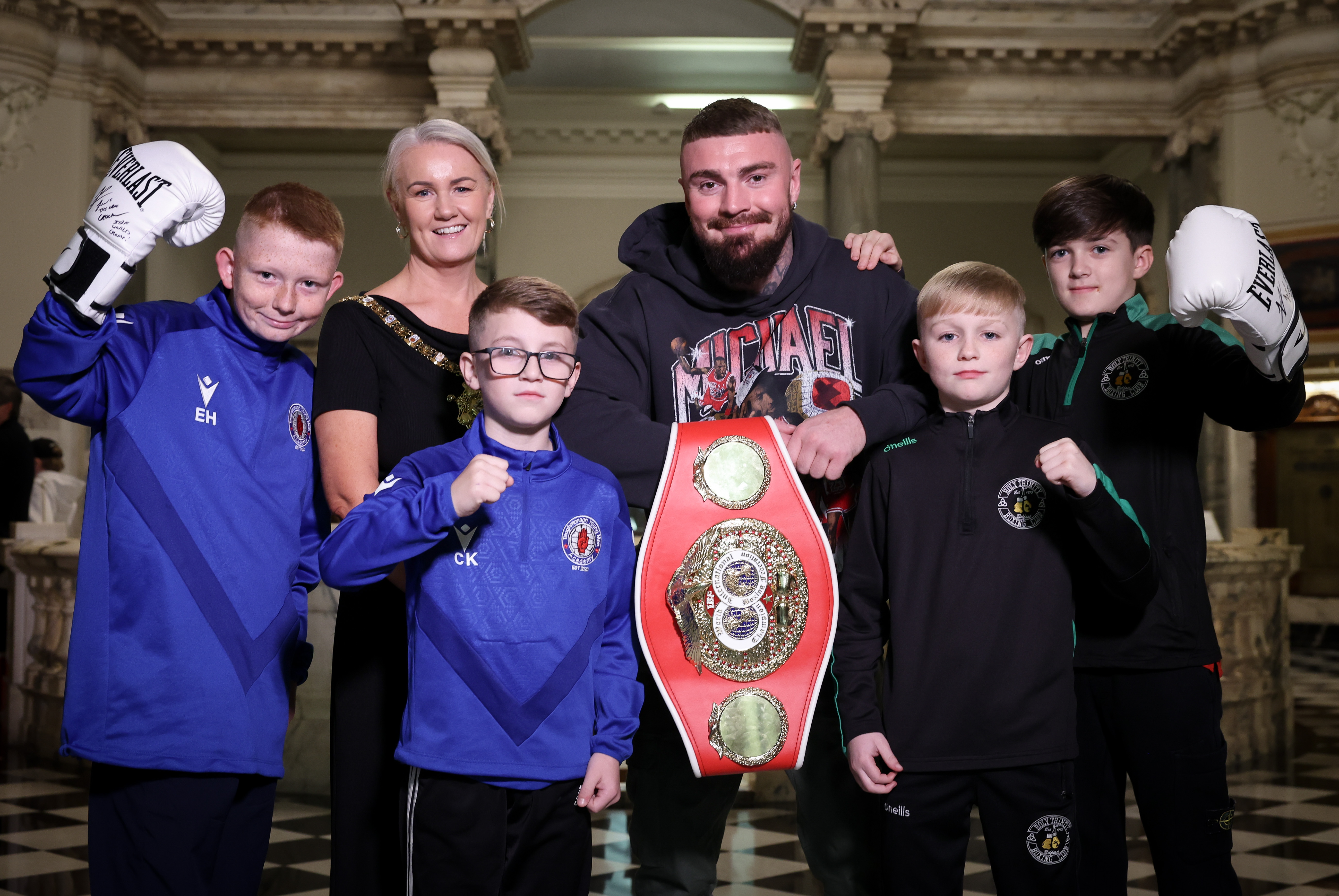 Lord Mayor of Belfast, Councillor Tracy Kelly, with world champion Lewis Crocker and young boxers inside City Hall. 