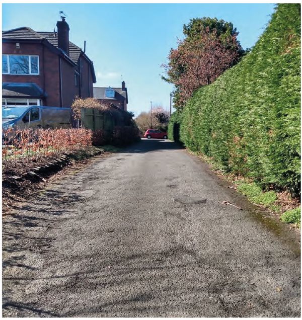 Photograph of an unadopted access road  connecting backland development with existing roads infrastructure.