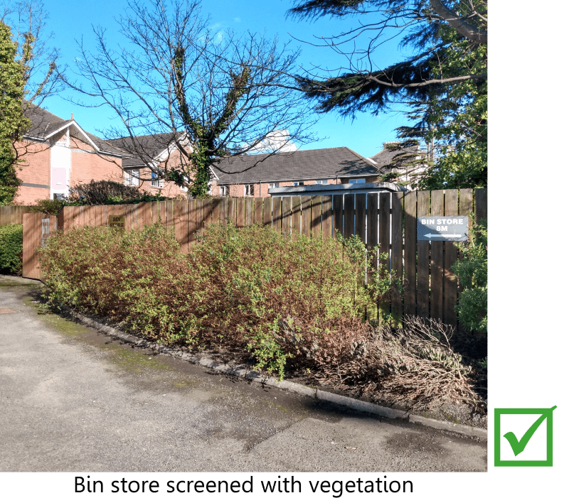 Bin store screened by vegetation.