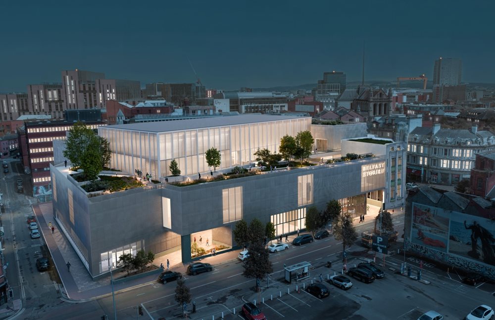 A computer generated image of the aerial view of Belfast Stories at night-time with the inside of the building and the rooftop garden lit up.