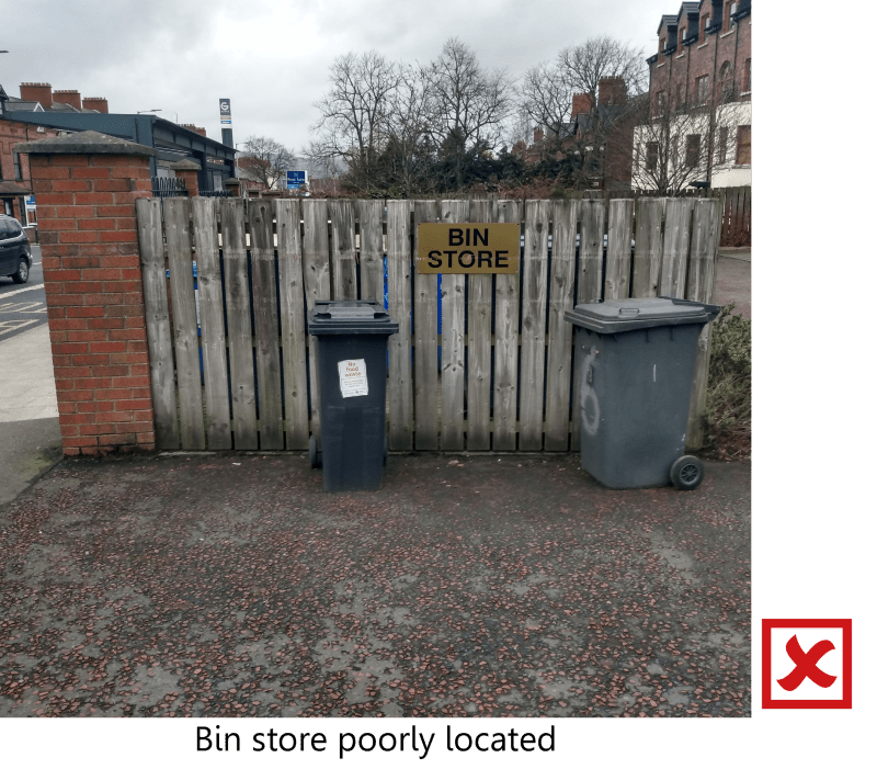 Poorly located bin store in visible communal area.
