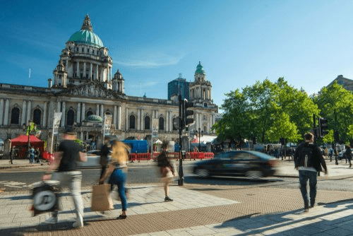 Shoppers, pedestrians and vehicles outside City Hall in Belfast city centre.