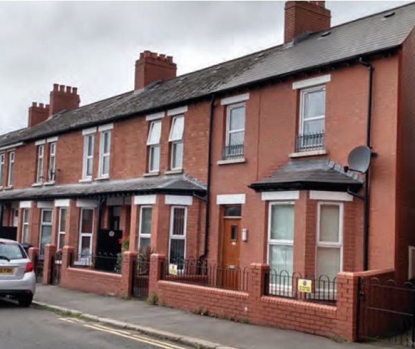 A row of terraced dwellings that has been extended with the addition of an end-terrace property designed and constructed to complement the architectural style and materials common to the adjoining properties.