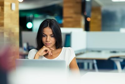 Woman reading laptop computer screen