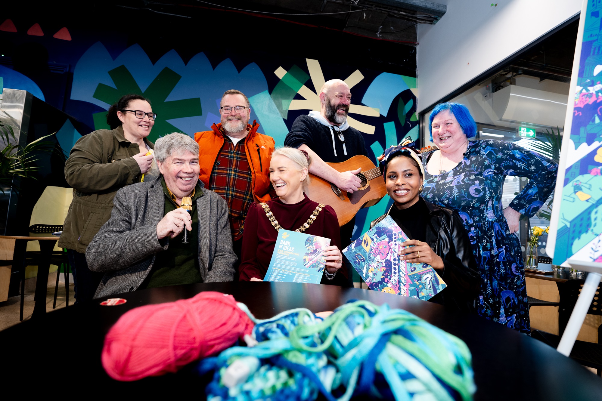 Lord Mayor of Belfast, Councillor Tracy Kelly, joins Belfast residents to launch this year’s Bank of Ideas scheme, with the group holding colourful props, including knitting needles, guitars and a mic