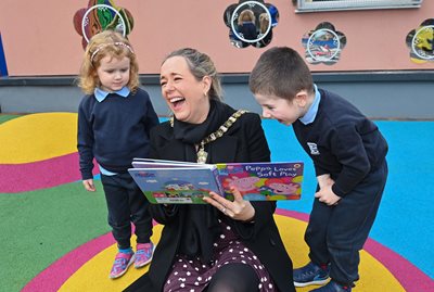 Lord Mayor of Belfast, Councillor Kate Nicholl shares a laugh with three-year-olds Ria and Ben in the newly refurbished playground at South Belfast Sure Start.