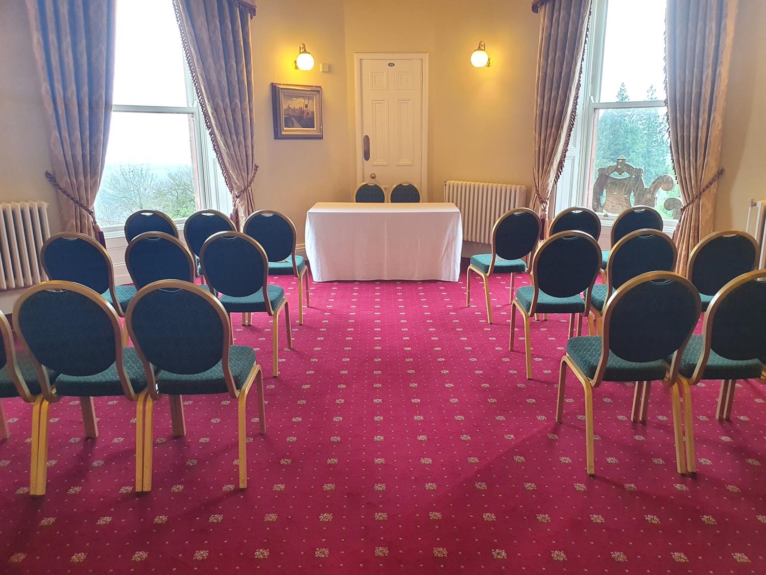 Fisherwick Room set up for an intimate wedding ceremony with chairs on either side of an aisle and a table for the couple.
