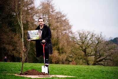 Councillor Micky Murray plants a tree at Barnett Demesne.