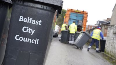 Belfast City Council bin and workers in the background
