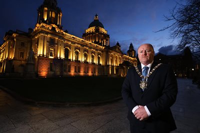 Lord Mayor of Belfast, Alderman Frank McCoubrey, outside City Hall at dusk