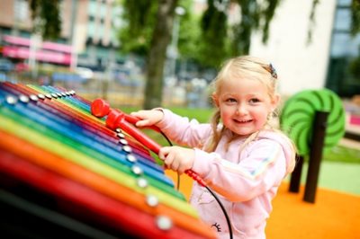 Girl playing in family-friendly zone in family-friendly zone at Cathedral Gardens, Belfast.